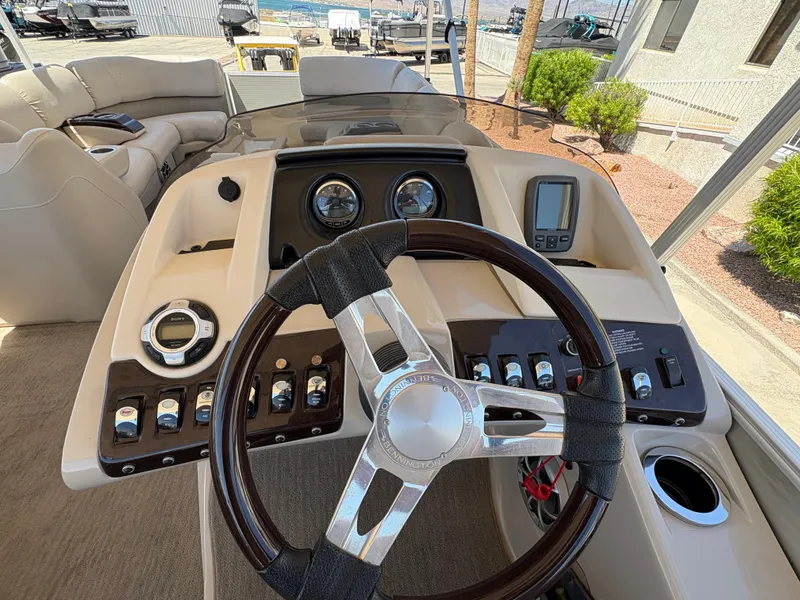 Slide: The Image of 2013 Bennington 2575 RCW IO boat dashboard with steering wheel and control panel. - 10