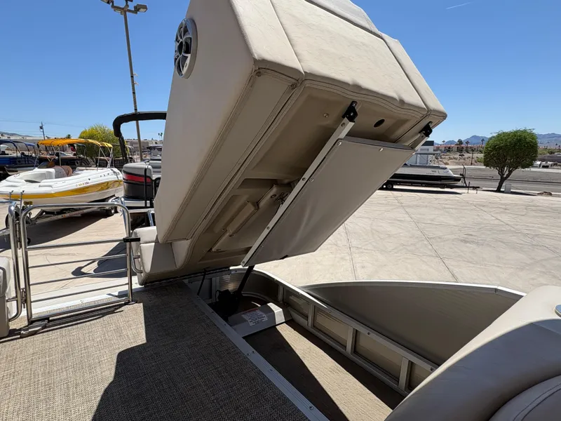 Slide: The Image of 2013 Bennington 2575 RCW IO boat with open storage compartment on deck. - 15