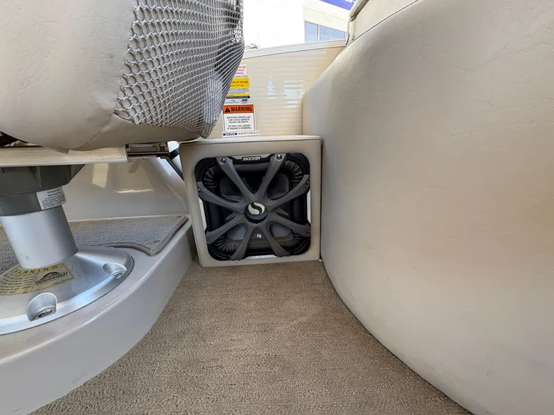 Slide: The Image of 2013 Bennington 2575 RCW IO boat interior with speaker and seating detail. - 16