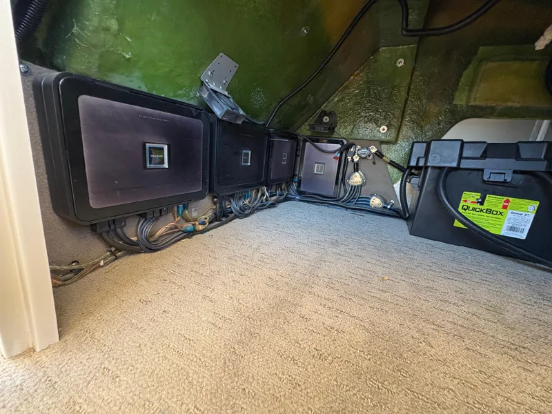 Slide: The Image of Electrical components inside a 2013 Bennington 2575 RCW IO boat, featuring wiring and a battery box. - 17