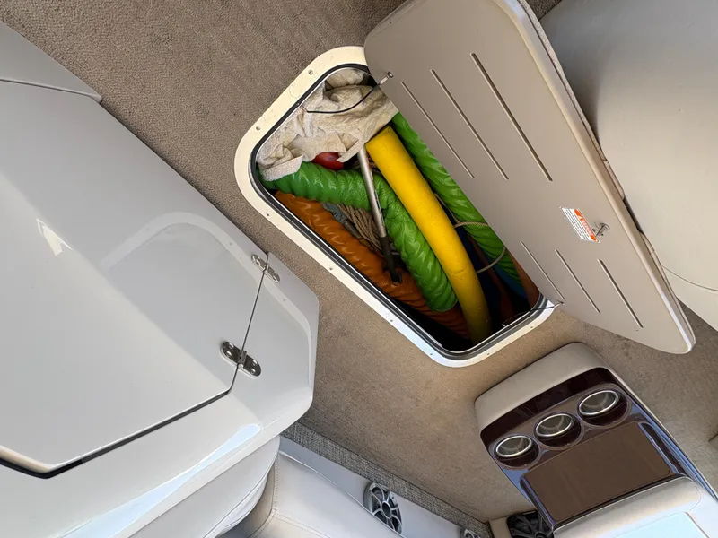 Slide: The Image of Storage compartment on 2013 Bennington 2575 RCW IO boat with colorful pool noodles. - 18