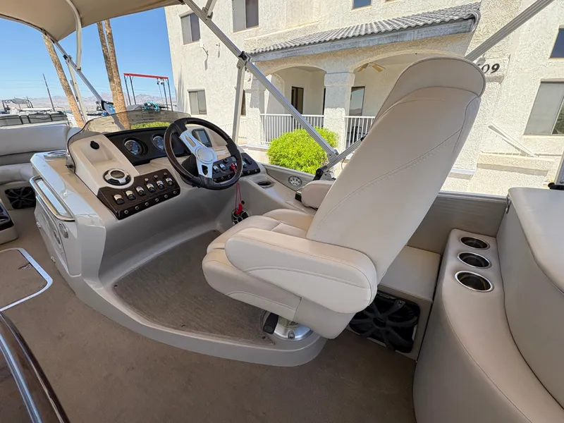 Slide: The Image of 2013 Bennington 2575 RCW IO boat interior with helm, captain's chair, and control panel. - 8