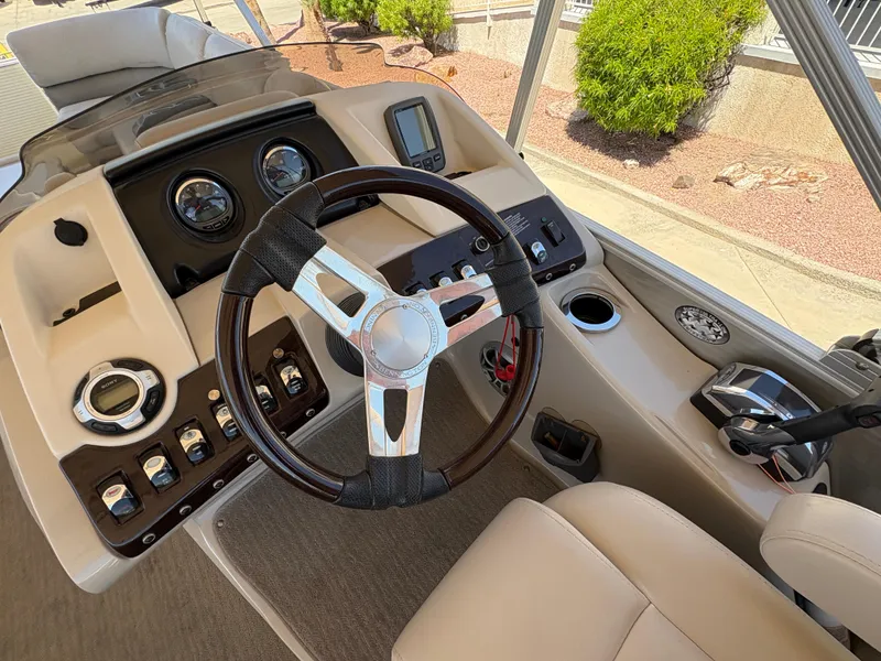 Slide: The Image of 2013 Bennington 2575 RCW IO boat dashboard with steering wheel and control panel. - 9