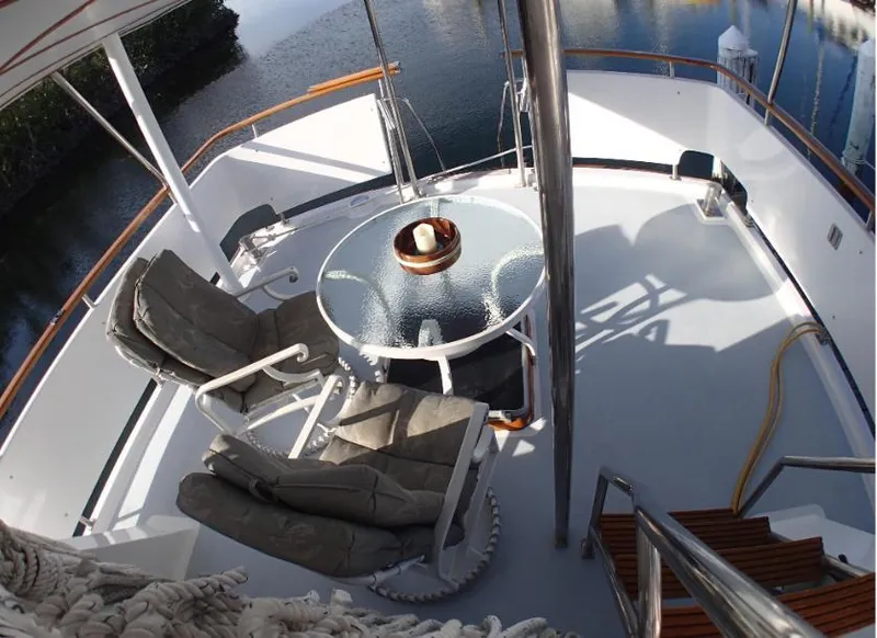 Slide: The Image of Tayana 45 Expedition Trawler 1987 deck with chairs and table, overlooking water. - 10