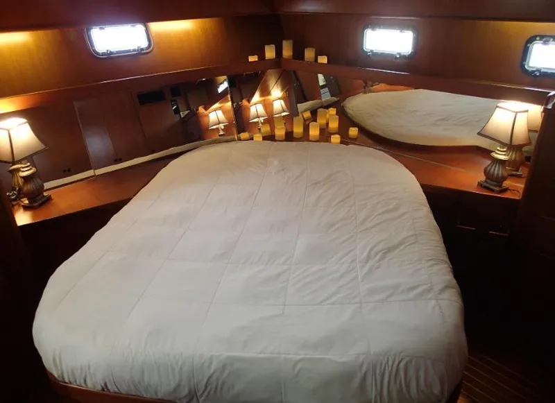 Slide: The Image of Cozy bedroom in 1987 Tayana 45 Expedition Trawler with ambient lighting and elegant decor. - 17