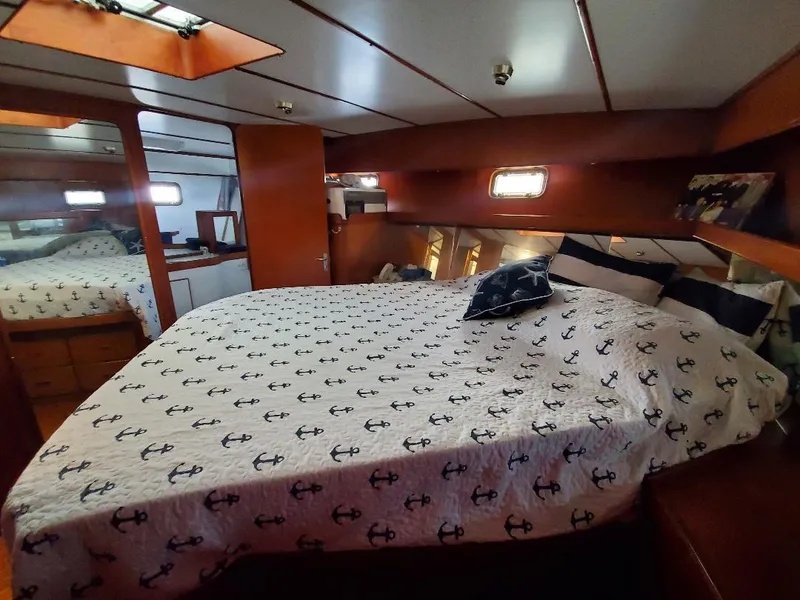 Slide: The Image of Cozy bedroom in 1987 Tayana 45 Expedition Trawler with anchor-themed bedding. - 18