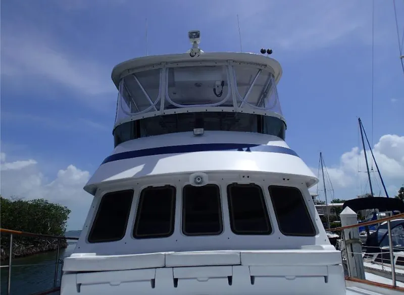 Slide: The Image of 1987 Tayana 45 Expedition Trawler docked under clear blue sky. - 6