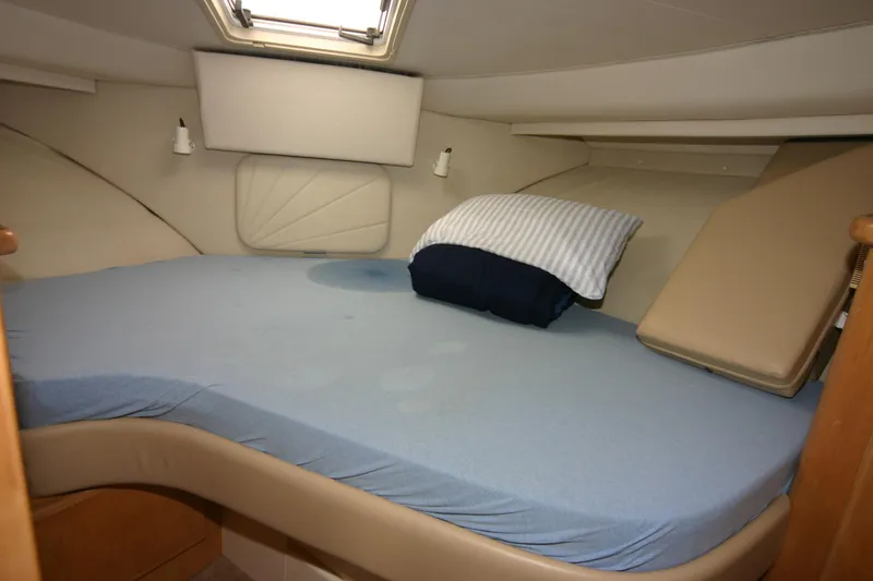 Slide: The Image of 1997 Carver 405 yacht cabin with a cozy bed and striped pillow. - 5