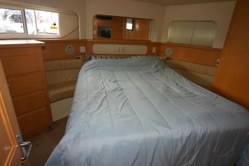 Slide: The Image of Interior of 1997 Carver 405 yacht with cozy bed and wooden furnishings. - 7