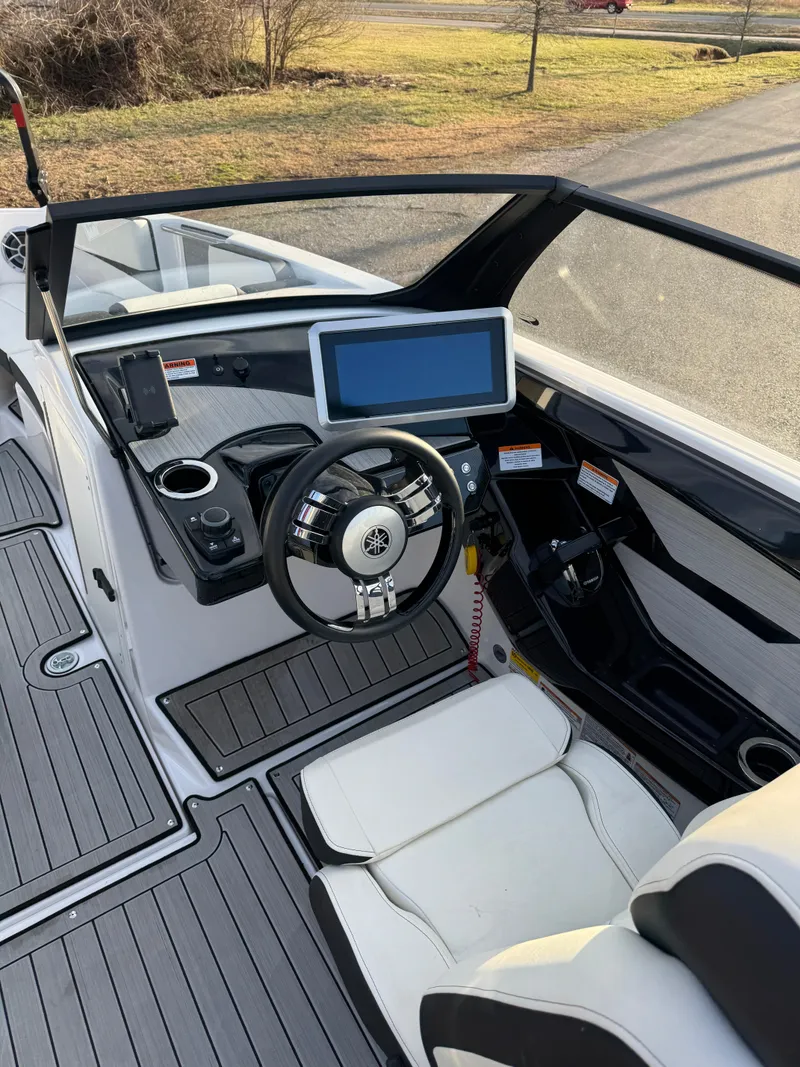Slide: The Image of 2024 Yamaha Boats 222SD cockpit with modern steering and touchscreen display. - 3