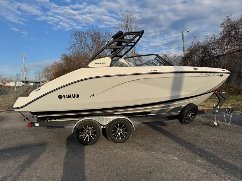 Slide: The Image of 2024 Yamaha Boats 222SD on trailer, side view, outdoors, clear sky. - 6