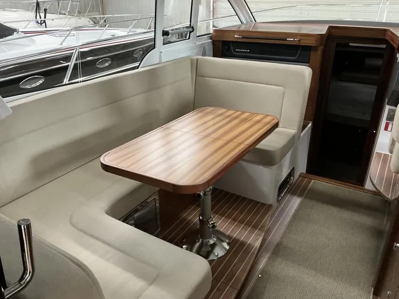 Slide: The Image of Interior of 2025 Nimbus 365 Coupe with elegant seating and wooden table. - 10