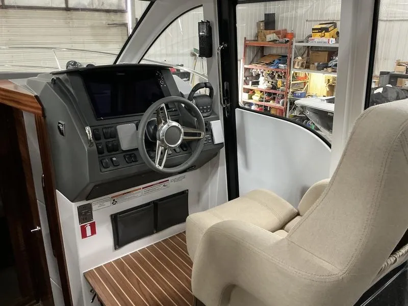 Slide: The Image of Pilot area of 2025 Nimbus 365 Coupe with modern controls and comfortable seating. - 11