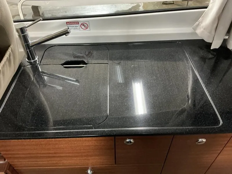 Slide: The Image of Modern kitchen sink in 2025 Nimbus 365 Coupe with sleek black countertop. - 14