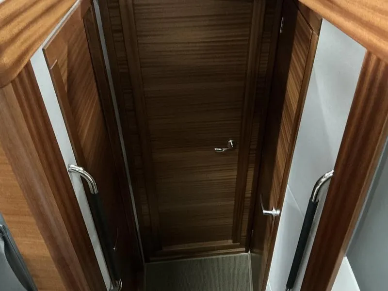 Slide: The Image of Interior hallway of 2025 Nimbus 365 Coupe with wooden doors and handles. - 17