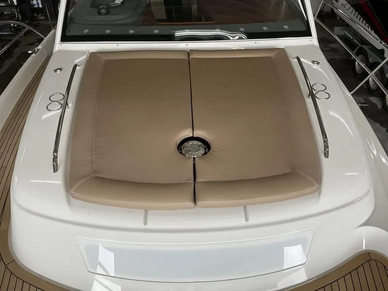 Slide: The Image of 2025 Nimbus 365 Coupe boat with beige cushioned deck and sleek design. - 22