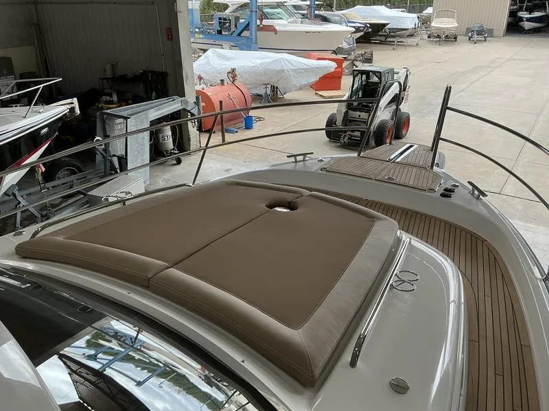 Slide: The Image of 2025 Nimbus 365 Coupe yacht with sun deck in a marina setting. - 23