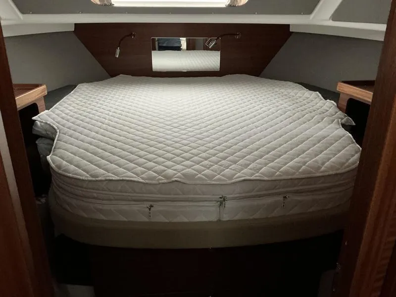 Slide: The Image of Luxurious cabin bed in 2025 Nimbus 365 Coupe yacht, featuring a quilted mattress. - 26