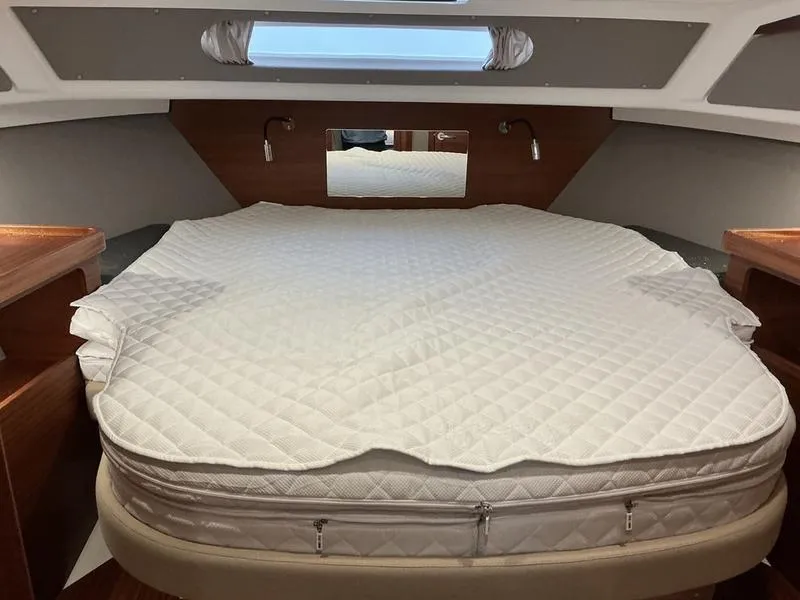 Slide: The Image of Cozy cabin interior of 2025 Nimbus 365 Coupe with a comfortable bed and wooden accents. - 28