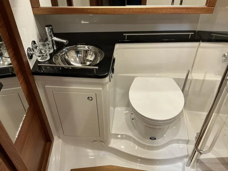 Slide: The Image of Luxurious bathroom in 2025 Nimbus 365 Coupe yacht with modern fixtures and sleek design. - 29