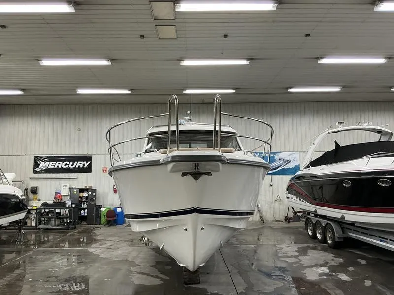Slide: The Image of 2025 Nimbus 365 Coupe boat in indoor showroom, front view. - 3