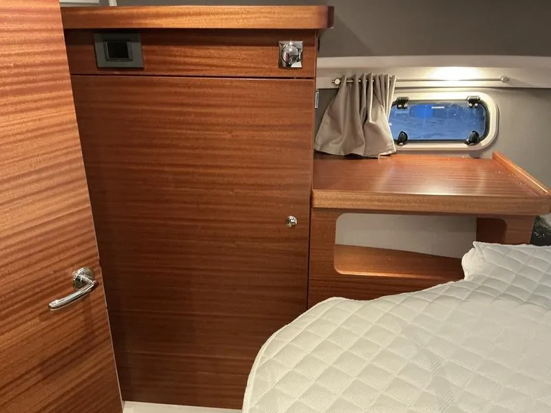 Slide: The Image of Interior of 2025 Nimbus 365 Coupe, featuring wood paneling and a cozy cabin space. - 31