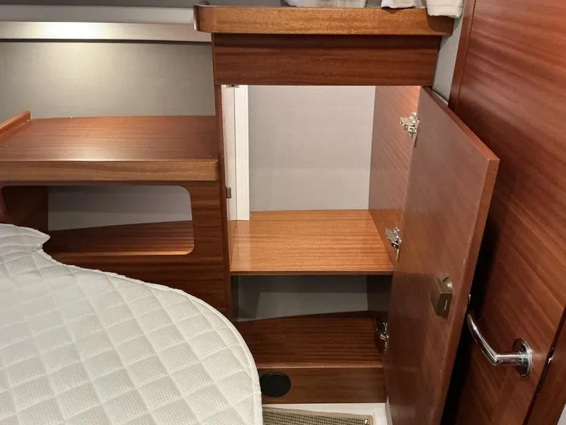 Slide: The Image of Interior of 2025 Nimbus 365 Coupe showing wooden cabinetry and storage space. - 33