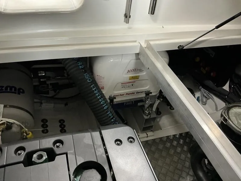 Slide: The Image of Engine compartment of a 2025 Nimbus 365 Coupe, showcasing mechanical components and generator. - 36