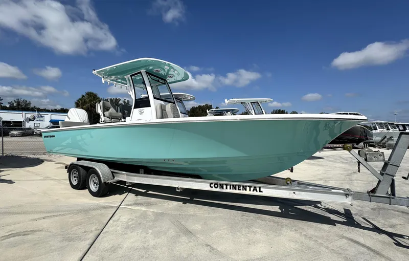 The Image of 2025 Sportsman Masters 267 boat on trailer under clear blue sky. - 0