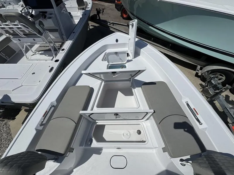 Slide: The Image of 2025 Sportsman Masters 267 boat interior with open storage compartments and seating. - 10