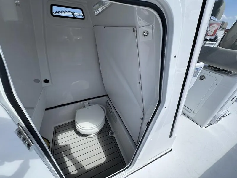 Slide: The Image of Compact bathroom inside a 2025 Sportsman Masters 267 boat, featuring a modern toilet. - 15