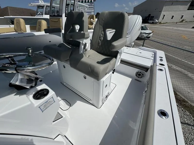 Slide: The Image of 2025 Sportsman Masters 267 boat interior with dual captain's chairs and steering wheel. - 16