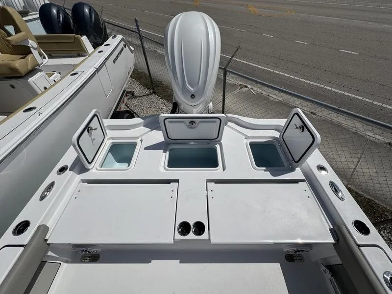 Slide: The Image of 2025 Sportsman Masters 267 boat deck with storage compartments and engine view. - 21