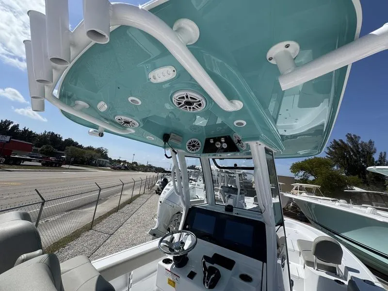 Slide: The Image of 2025 Sportsman Masters 267 boat interior with modern controls and teal canopy. - 23
