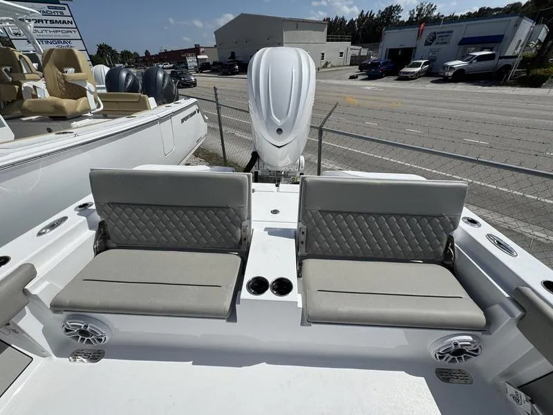 Slide: The Image of 2025 Sportsman Masters 267 boat with dual cushioned seats and outboard motor. - 24