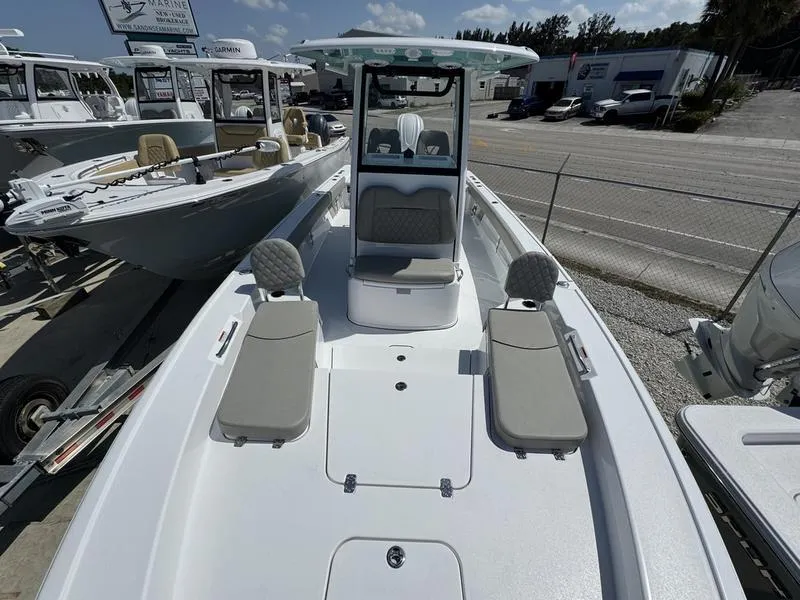 Slide: The Image of 2025 Sportsman Masters 267 boat with seating, docked at a marina under clear skies. - 4