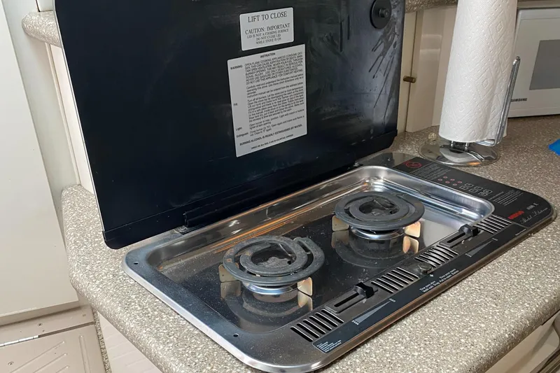 Slide: The Image of Two-burner stove on 2000 Maxim Yachts 3300SCR, set in a compact kitchen area. - 18