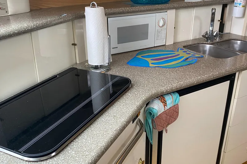 Slide: The Image of Maxim Yachts 3300SCR 2000 model kitchen with microwave, sink, and countertop appliances. - 19