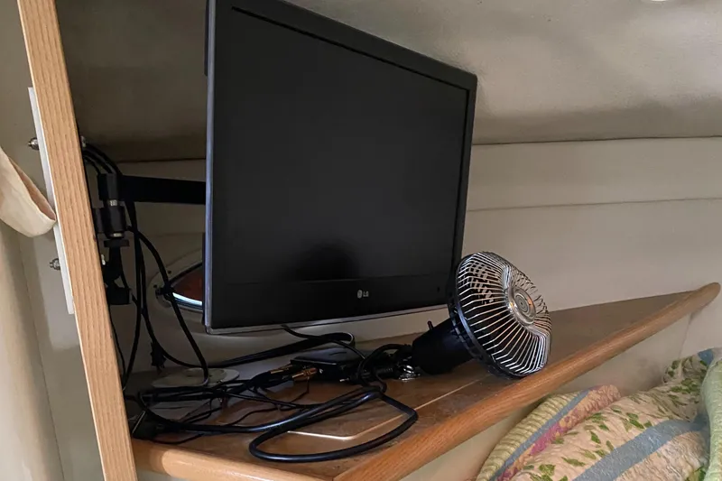 Slide: The Image of TV and fan setup on Maxim Yachts 3300SCR, 2000 model, wooden shelf. - 21