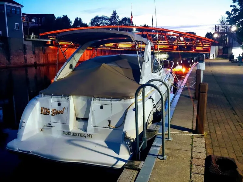 Slide: The Image of Maxim Yachts 3300SCR 2000 docked near illuminated bridge at dusk. - 5