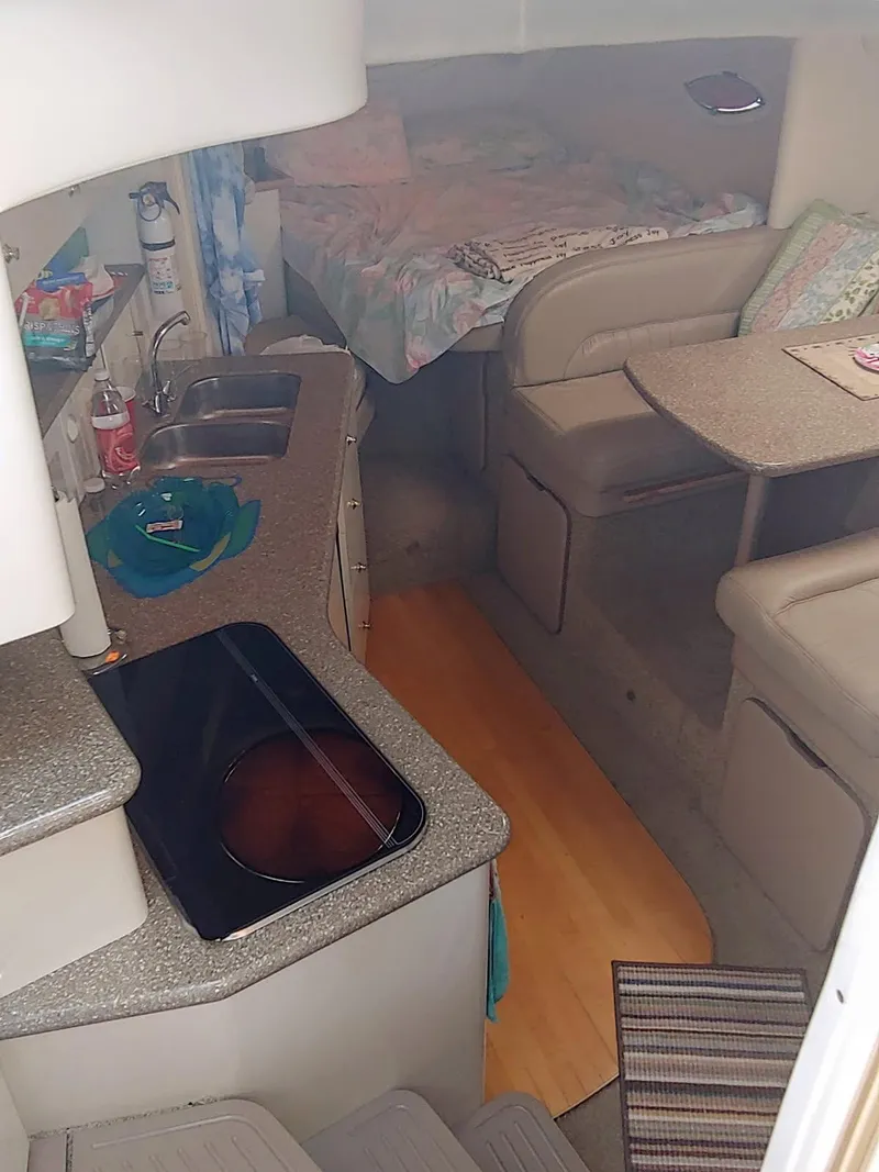 Slide: The Image of Interior of 2000 Maxim Yachts 3300SCR, featuring kitchen, seating, and sleeping area. - 6