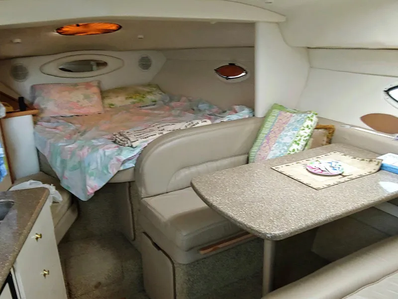 Slide: The Image of Interior of 2000 Maxim Yachts 3300SCR with cozy bed and dining area. - 9