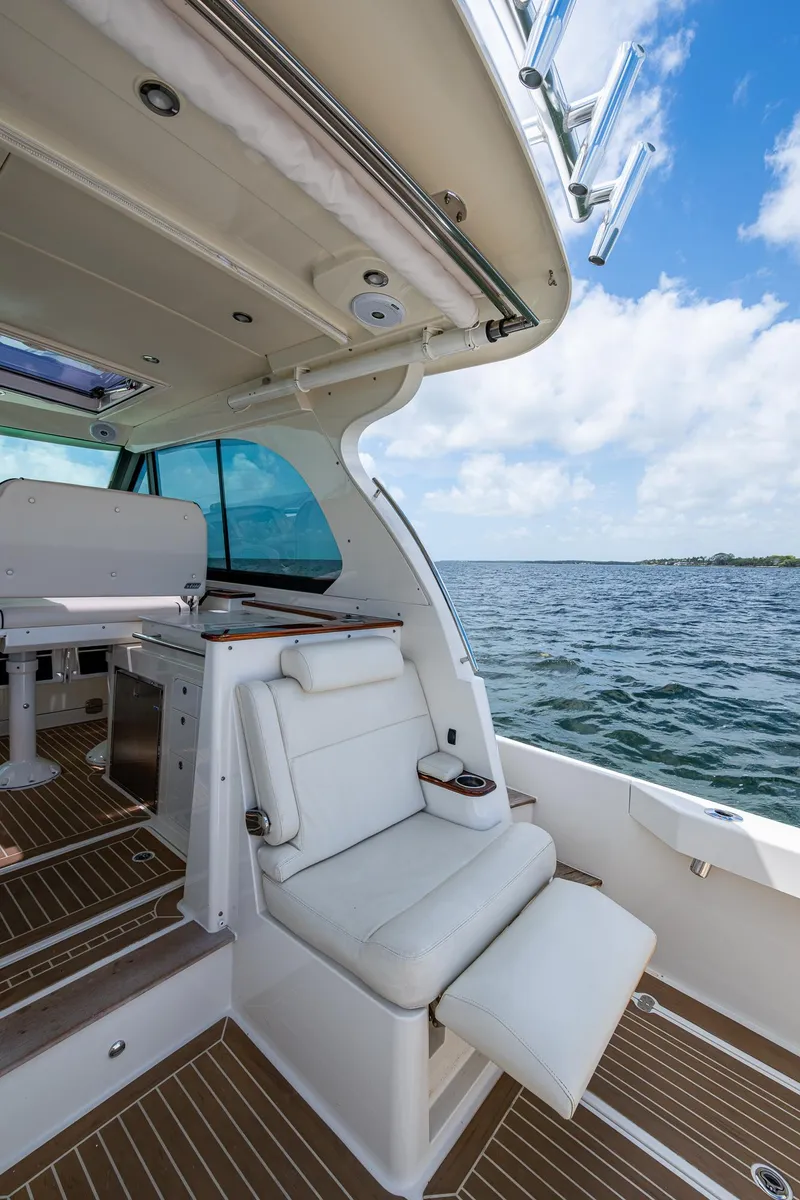 Slide: The Image of 2021 Hinckley Sport Boat 40 X interior with luxurious seating and ocean view. - 11
