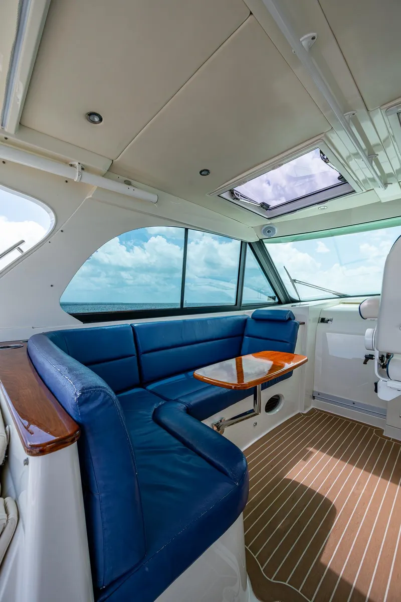 Slide: The Image of Interior of 2021 Hinckley Sport Boat 40 X with blue seating and ocean view. - 14