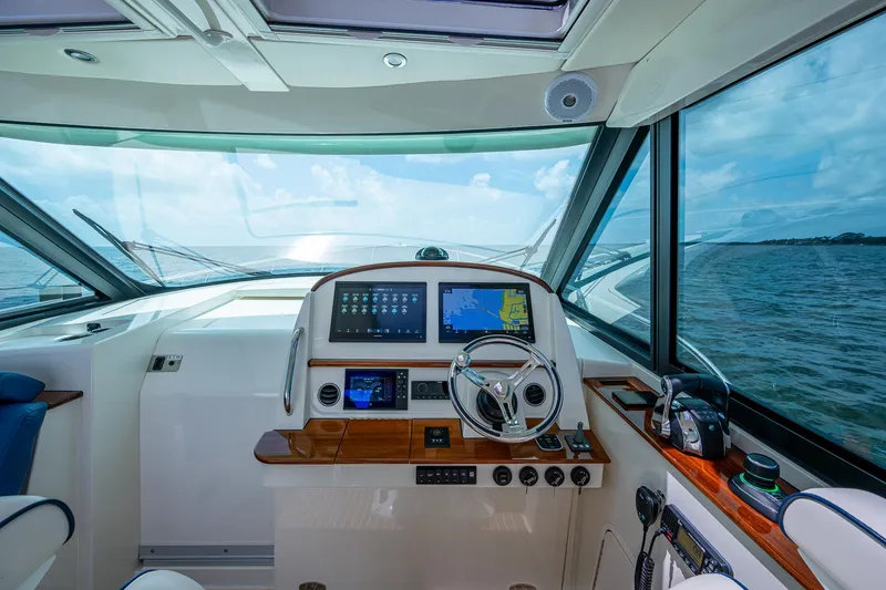 Slide: The Image of Interior view of 2021 Hinckley Sport Boat 40 X helm with navigation screens. - 18