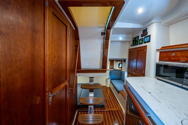 Slide: The Image of Interior of 2021 Hinckley Sport Boat 40 X with wood finishes and modern amenities. - 19