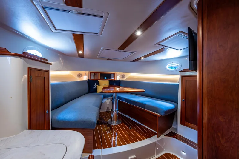 Slide: The Image of Interior of 2021 Hinckley Sport Boat 40 X with elegant seating and wooden finishes. - 21