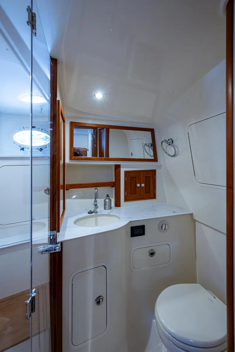 Slide: The Image of 2021 Hinckley Sport Boat 40 X bathroom with modern fixtures and wooden accents. - 25