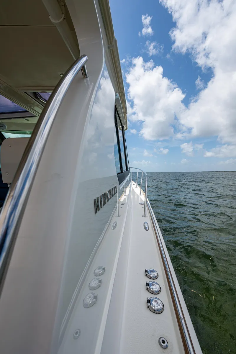 Slide: The Image of Hinckley Sport Boat 40 X, 2021 model, cruising on open water under a blue sky. - 28