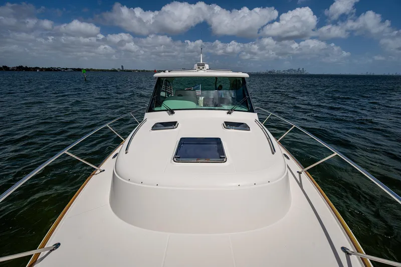 Slide: The Image of 2021 Hinckley Sport Boat 40 X on open water under a partly cloudy sky. - 30